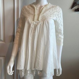 White lace blouse with pearl accents